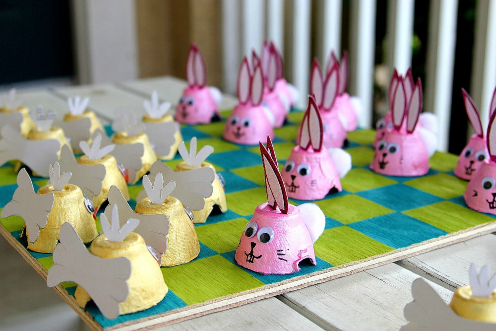 A game of Easter checkers with paper rabbits and chickens.