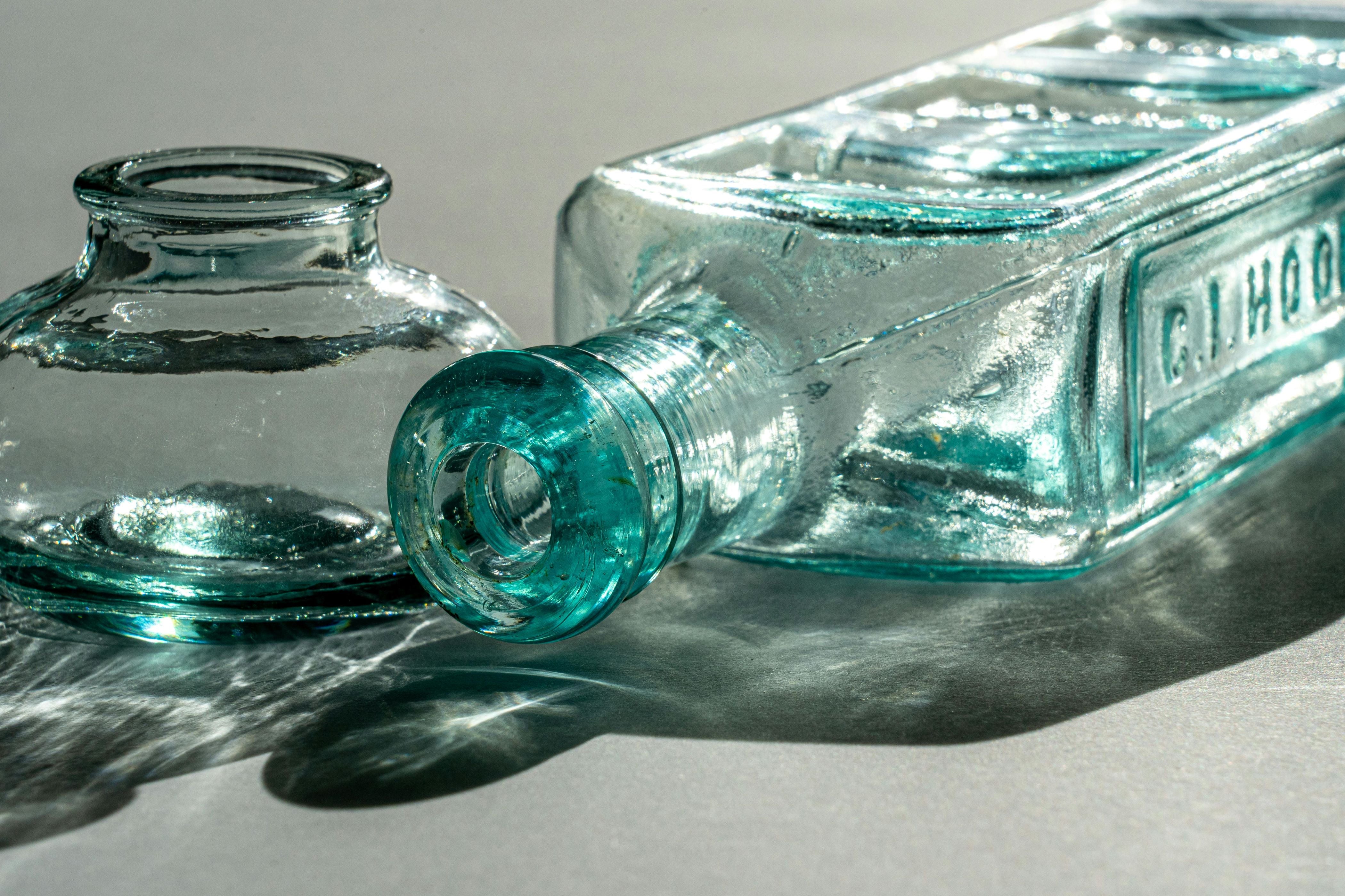 2 glass bottles with blue tinged glass