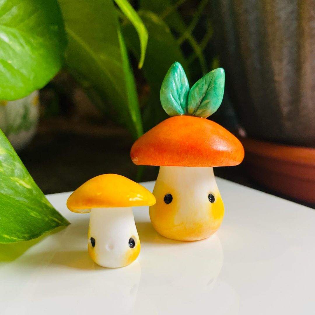 2 porcini mushroom sculptures with eyes and blush