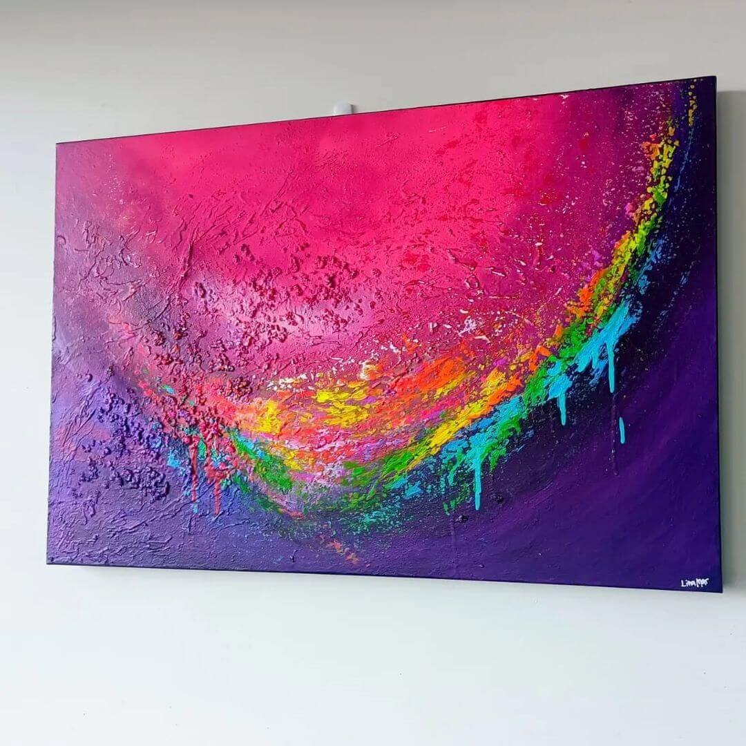 A textured, coloured abstract canvas hanging on a white wall with lines of bright colour on one side.