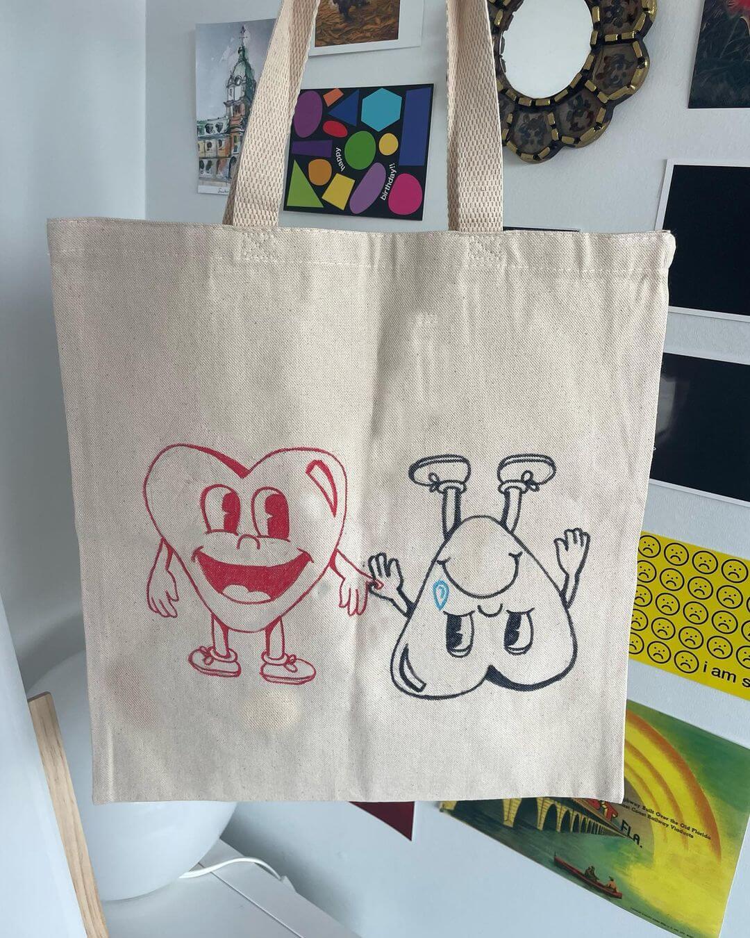 A tote bag with a red and blue cartoon love heart drawn on.