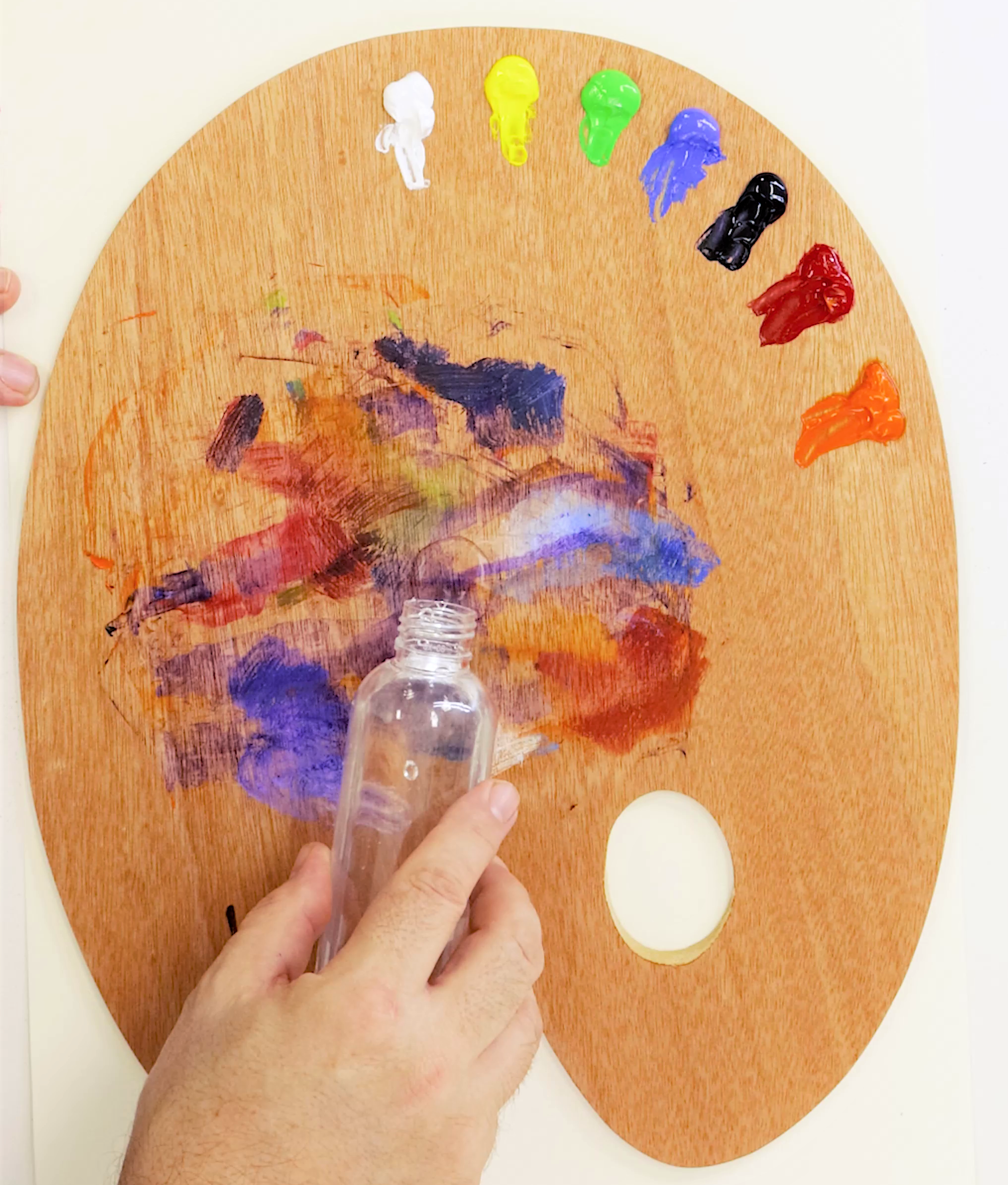 3. Adding solvent to a wood palette with oil paints on it