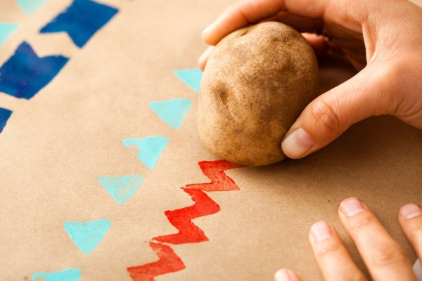 Potato being used to stamp Christmas cards.