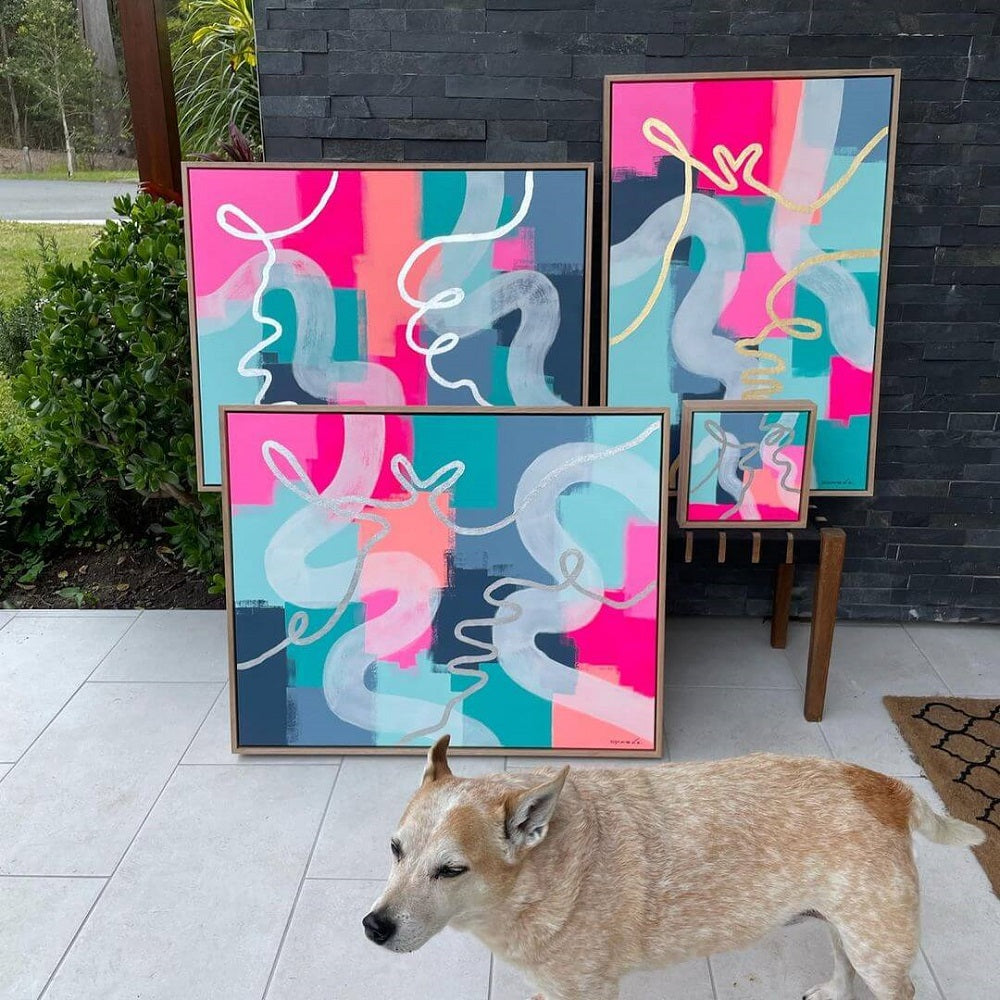 Four different sized canvases of abstract colour and Michelles dog in front.
