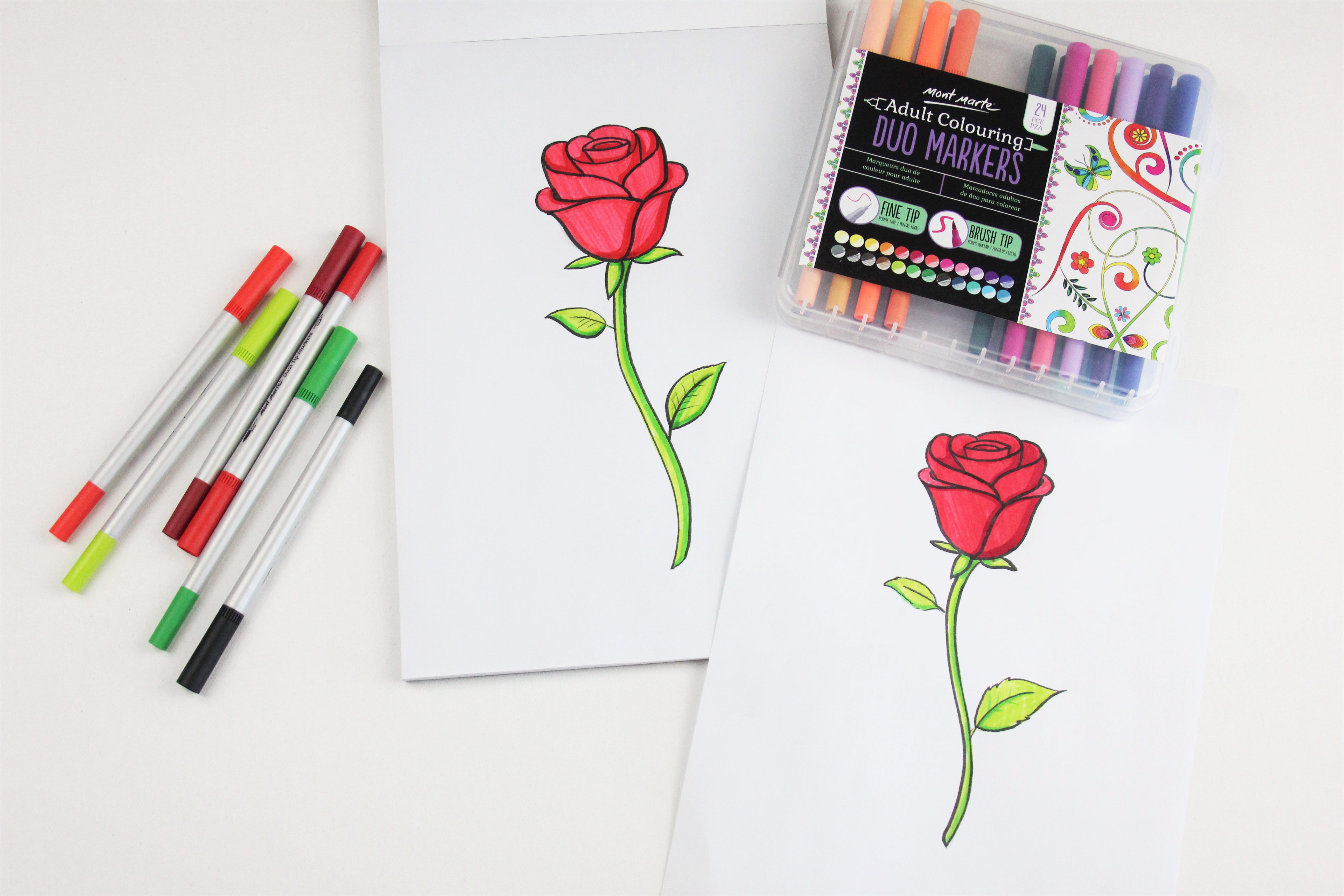 Two rose drawings in markers next to a pack of Mont Marte markers.