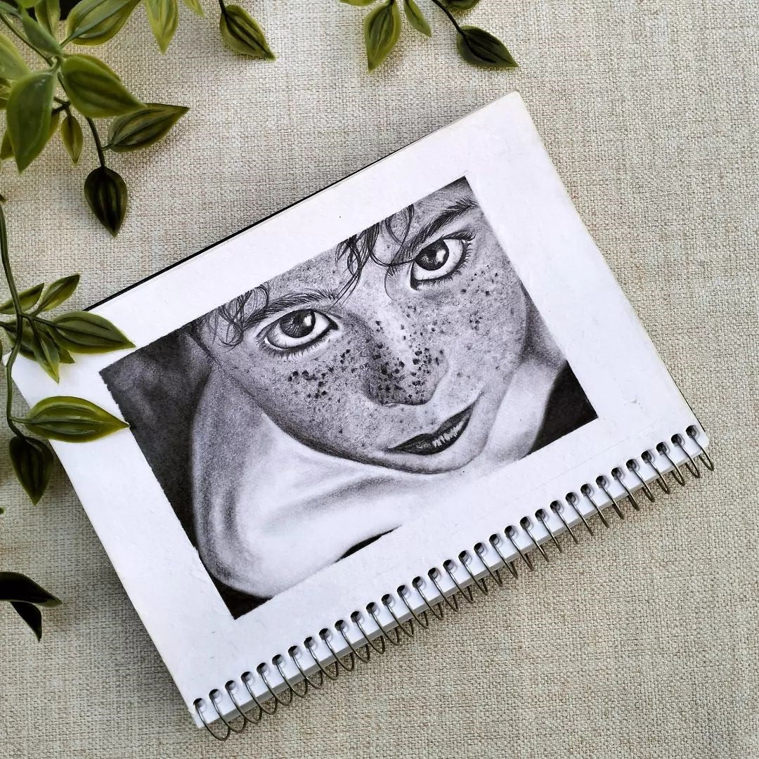 4. Greyscale portrait of a young boy looking up with freckles across his nose