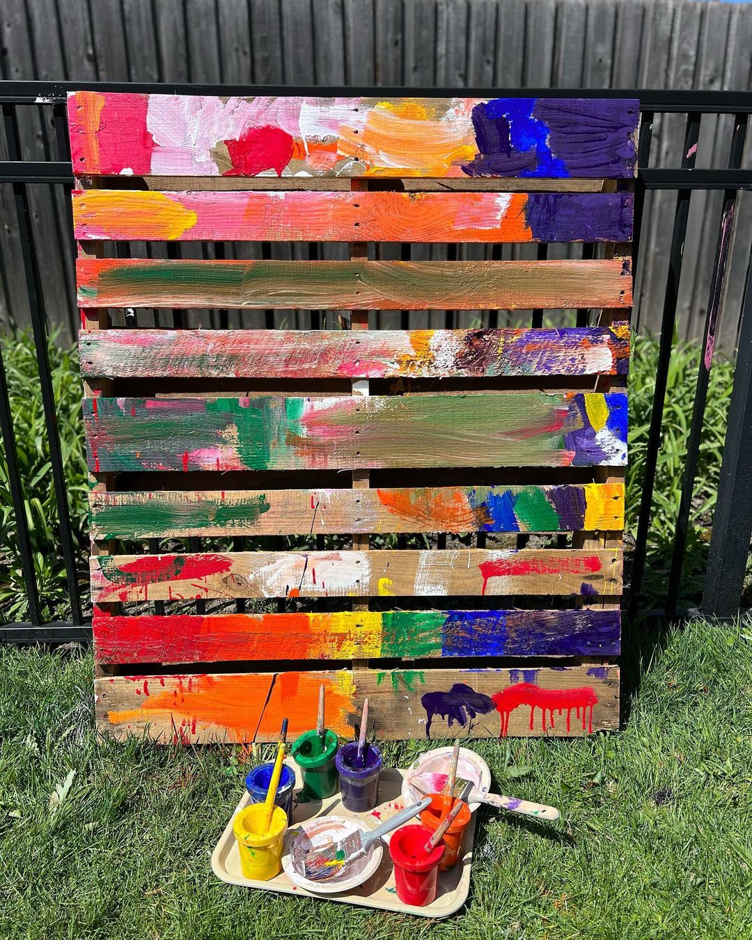 4. @preschoolforyou rainbow coloured action painting on an upright pallet