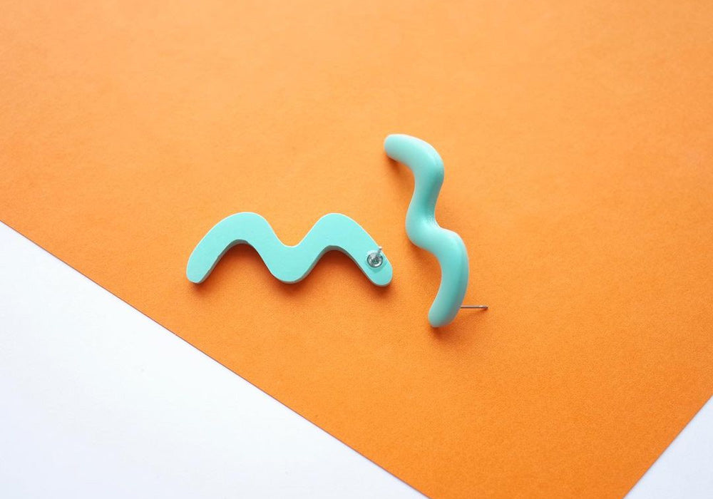 A pair of blue squiggly studs.