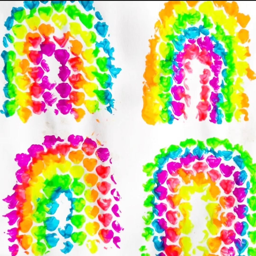 4 rainbow finger paintings on a white piece of paper