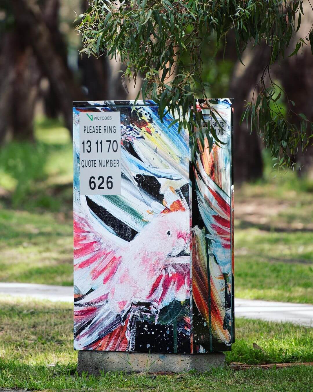 Photo of a brightly painted signal box in Cheong Park in Victoria of a pink cockatoo painted in acrylic.