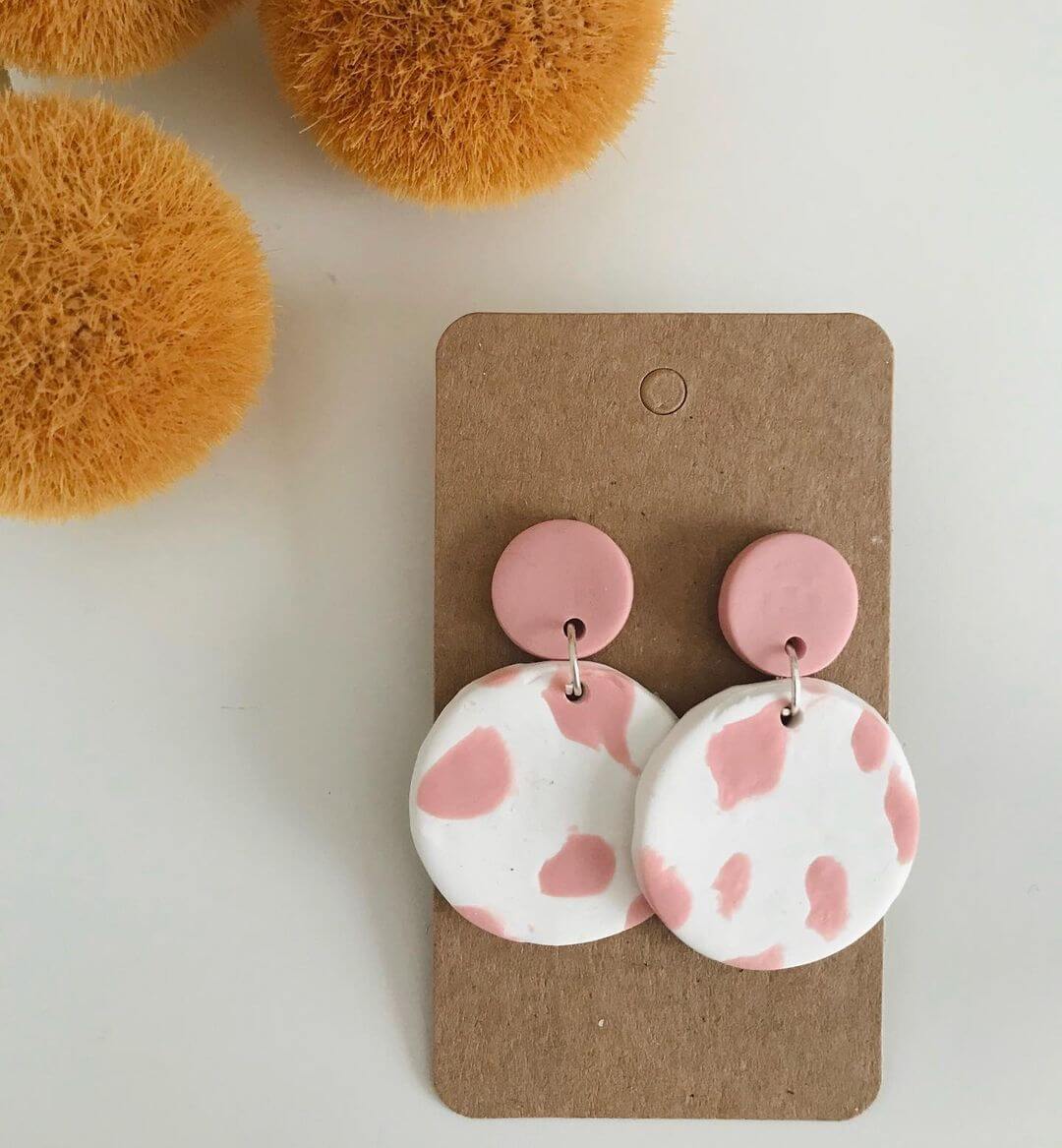 5. Polymer clay earrings with a pink and white cow print pattern