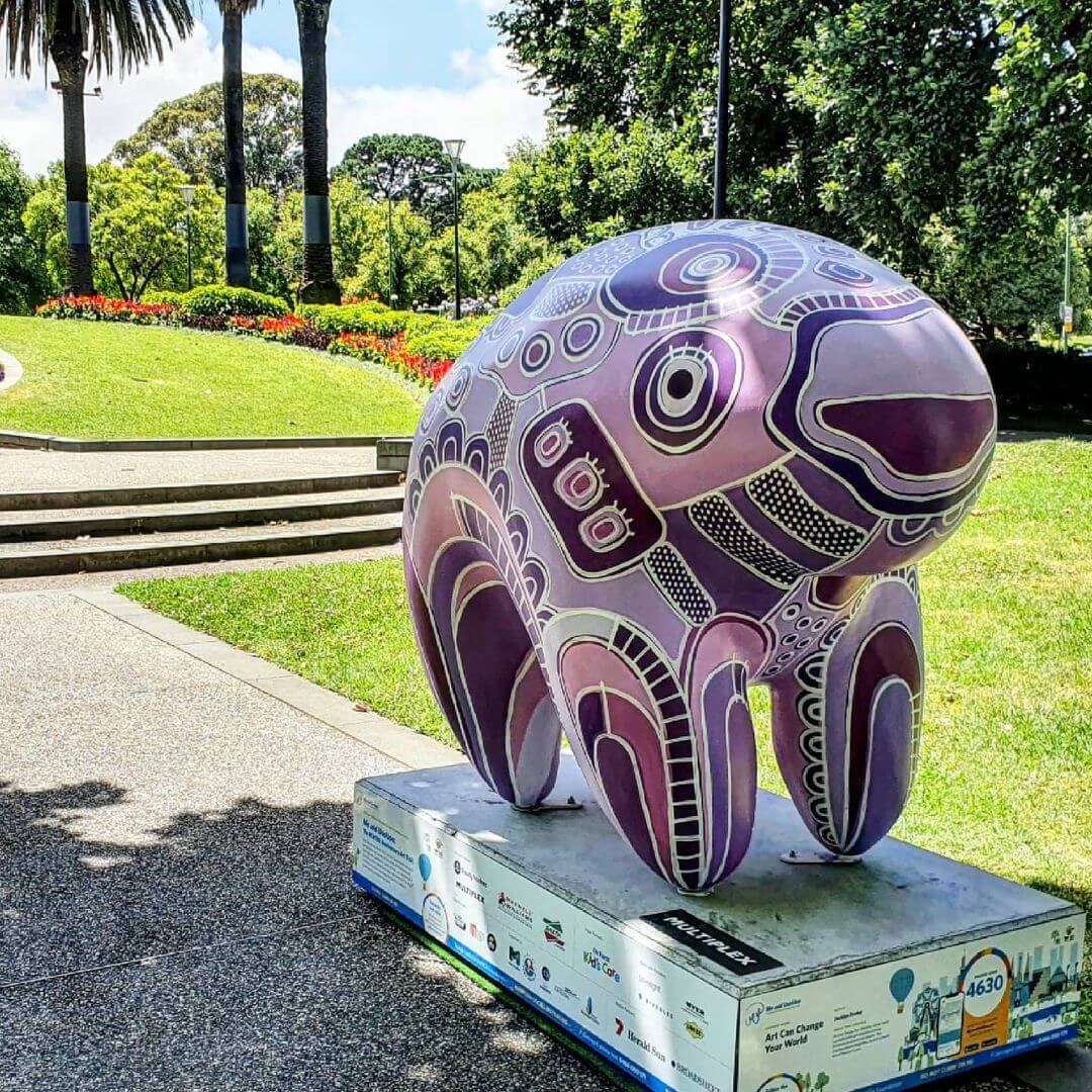 Art can change the world, wombat sculpture painted with abstract purple design in Queen Vic Gardens.