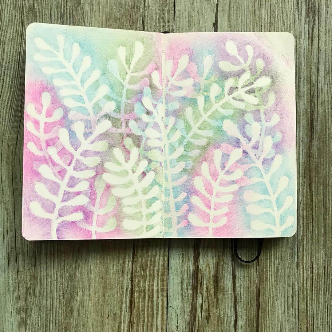 6. Ferns drawn in a notebook with with purple, green and blue backgrounds.