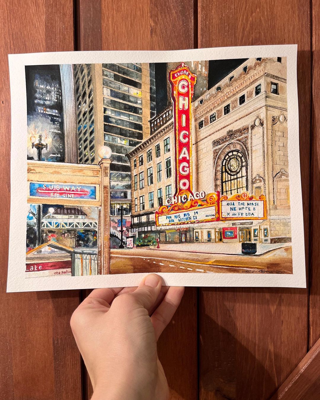 6. @chrissiguarnieriart painting of the Chicago Theatre with a subway sign in the foreground