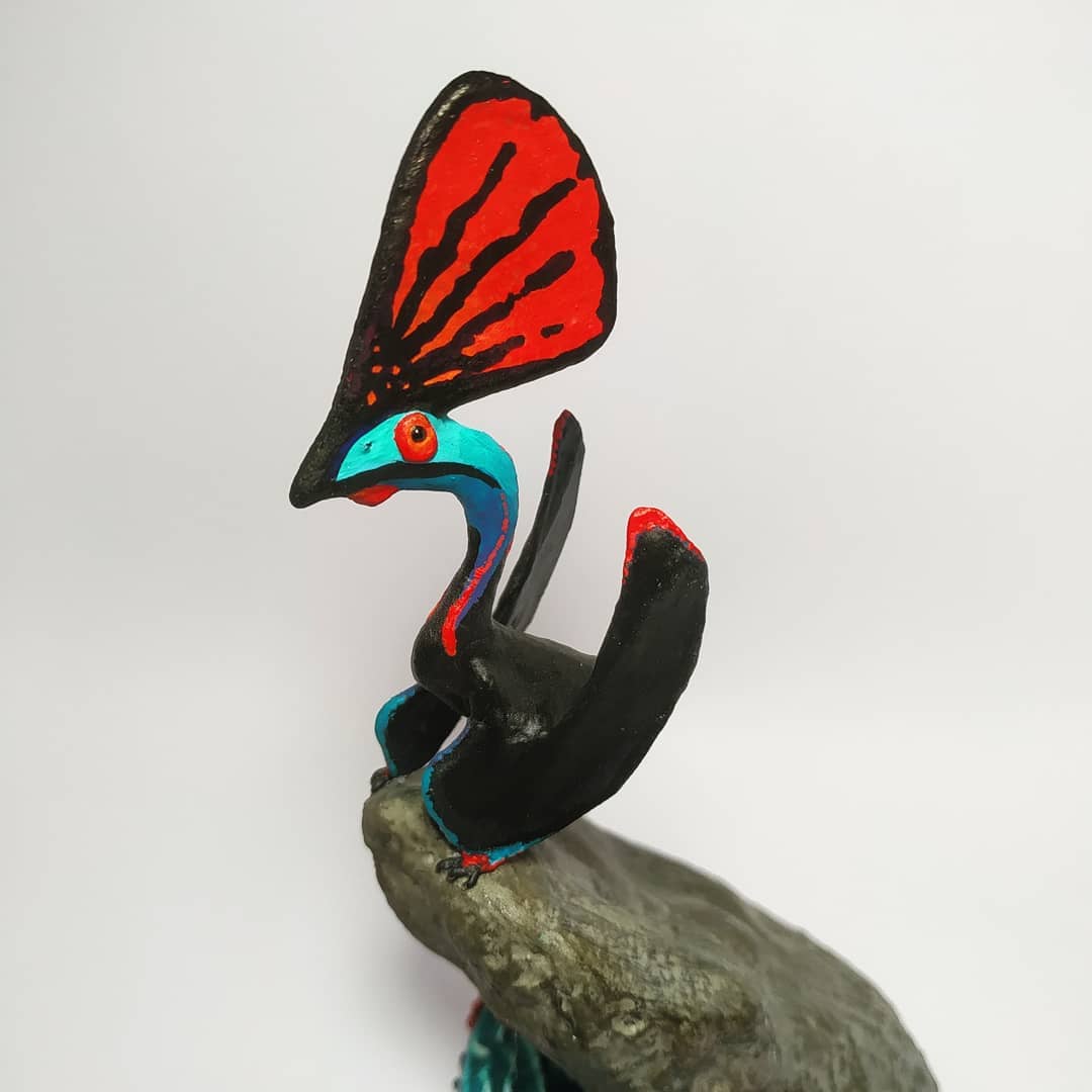 6. @juksart bightly coloured dinosaur sculpture with a blue head and red detailing