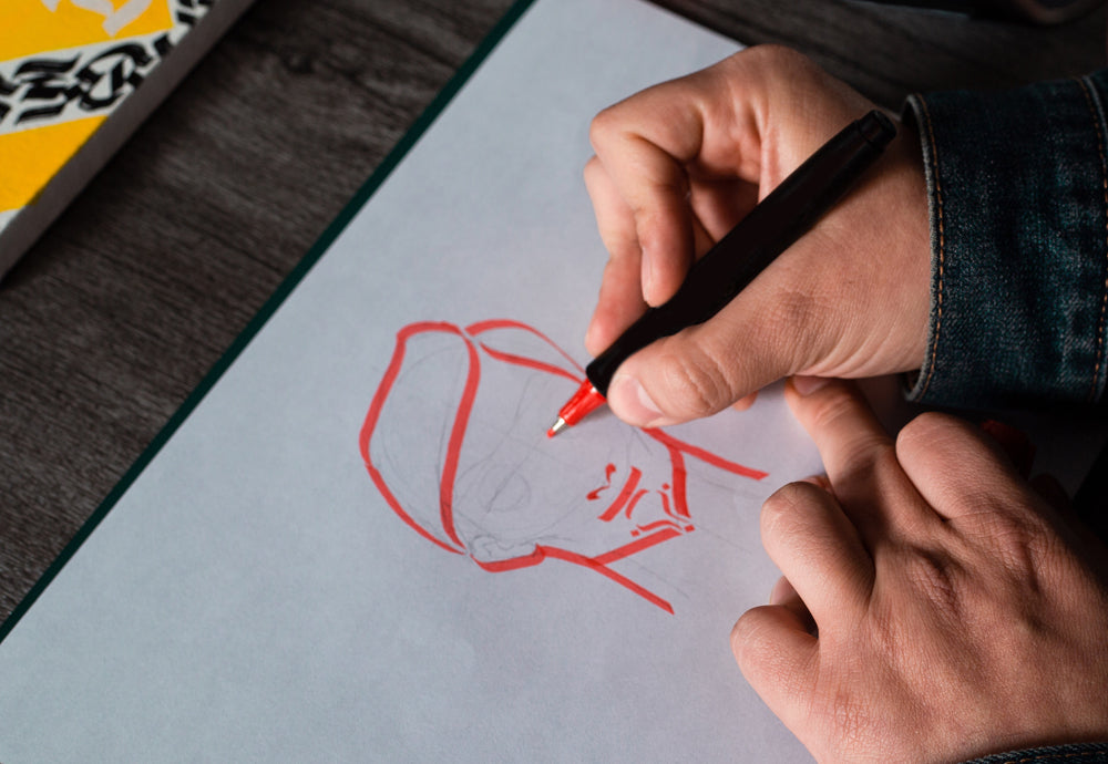 A red marker, drawing a portrait of a female.