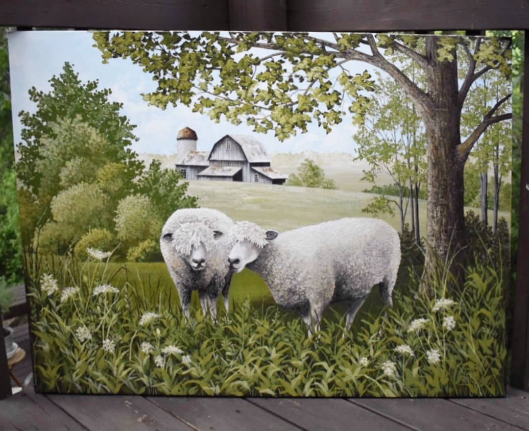 A realistic artwork of two sheep in a field with a country style farm house in the background.