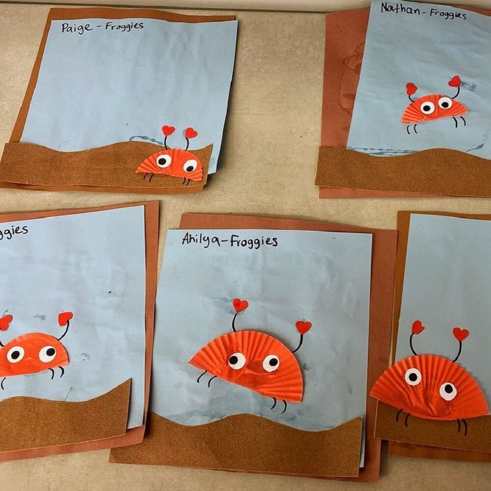 Bright orange crabs made from cupcake papers glued on to blue paper.