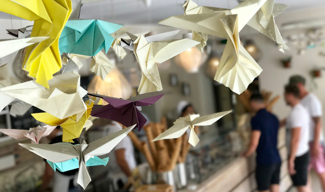 Several origami cranes in different paper colours.
