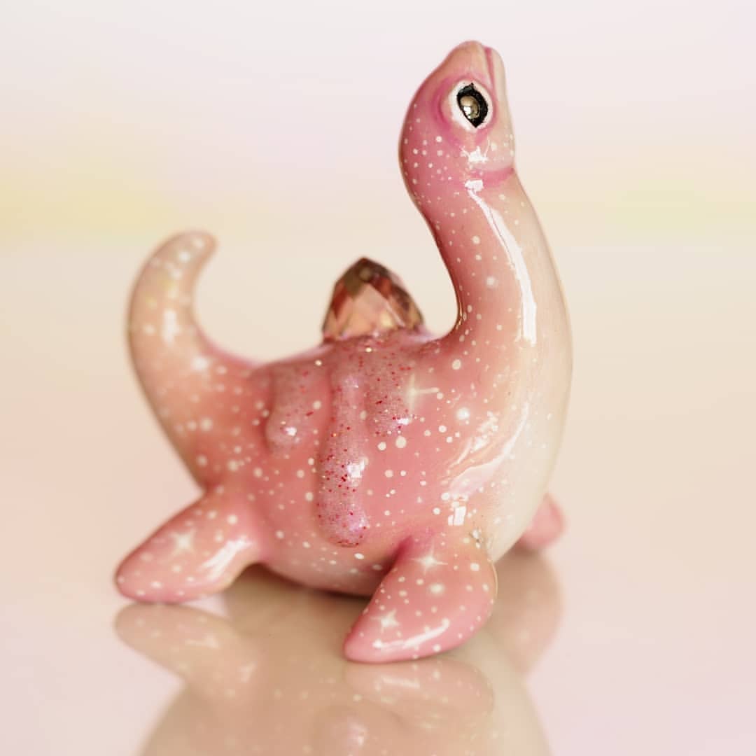 8. @maidarlingdesigns water dinosaur sculpture painted peachy pink with small star details