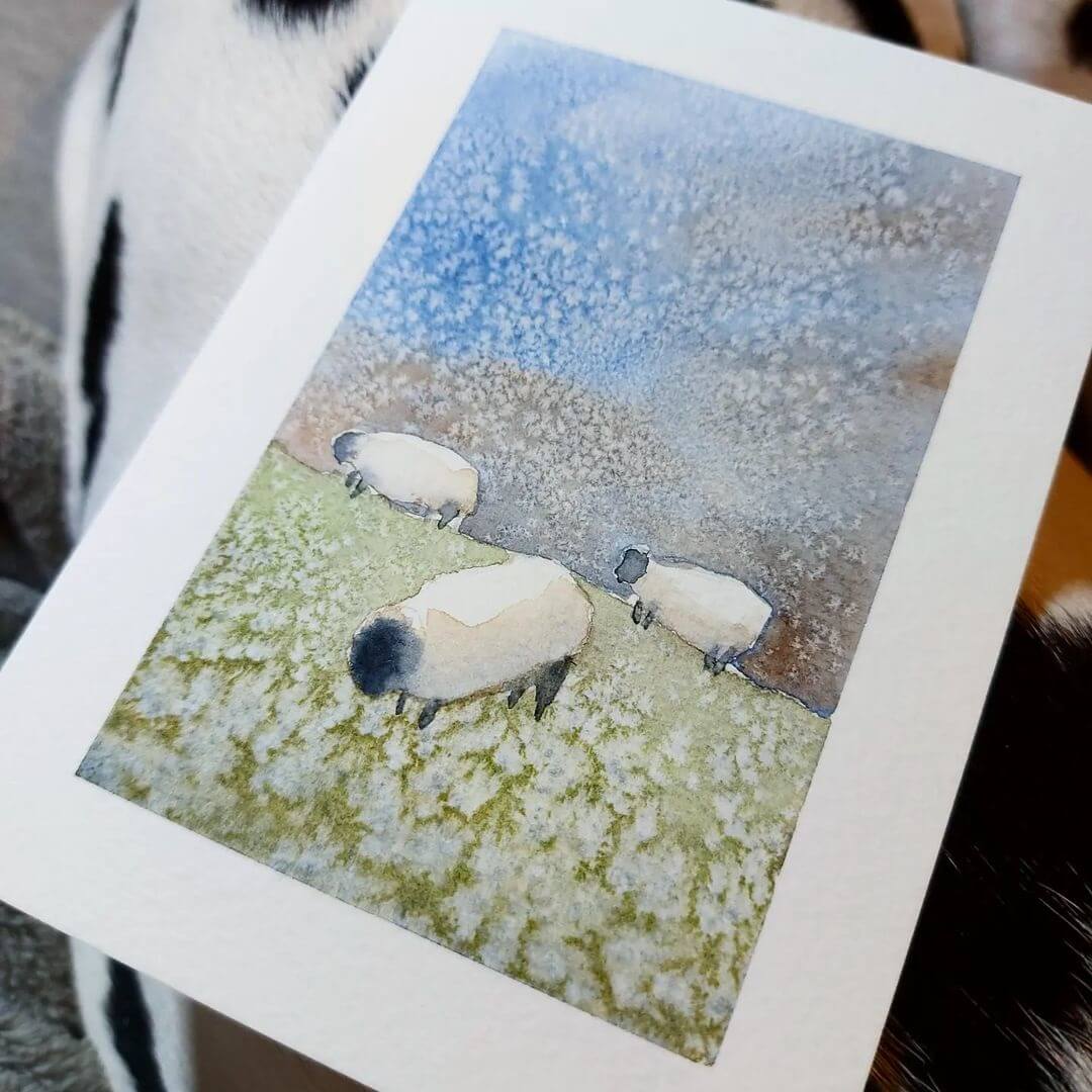 A watercolour painting of sheep in a green paddock with blue sky.