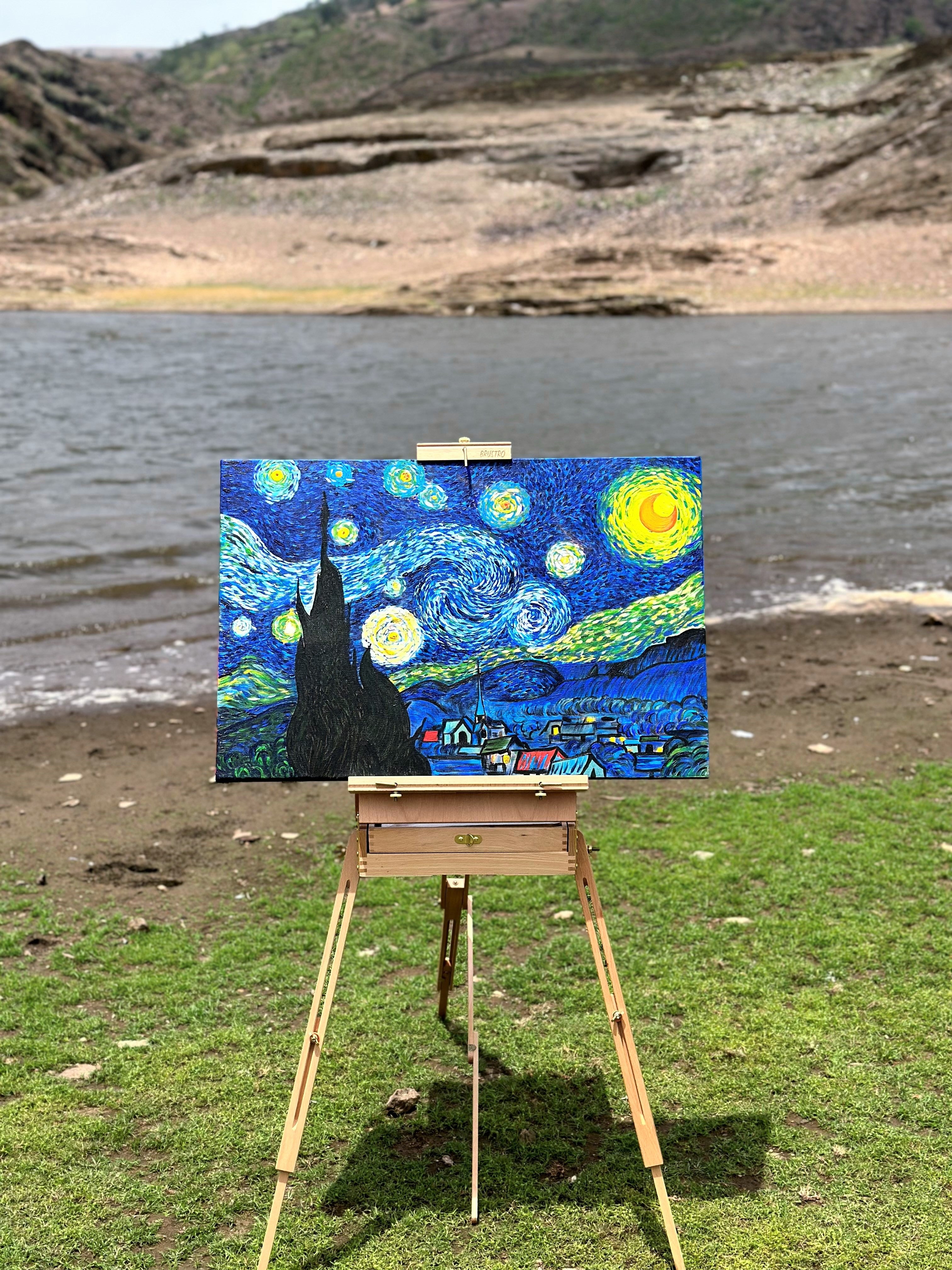 8. Starry Night painting in front of a body of water