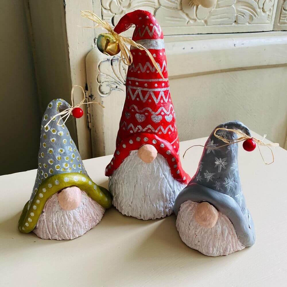 Three clay Christmas gnome heads.