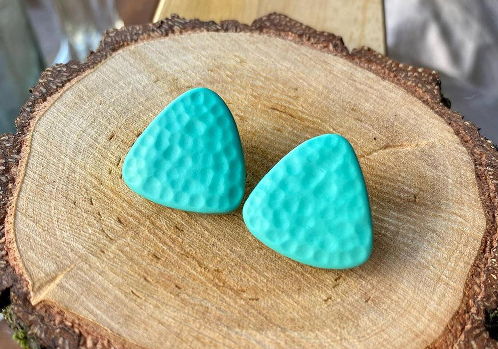 A pair of textured blue earring studs.