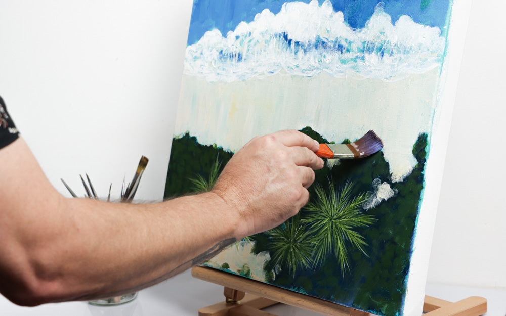 Varnish being applied to a painting of a shoreline