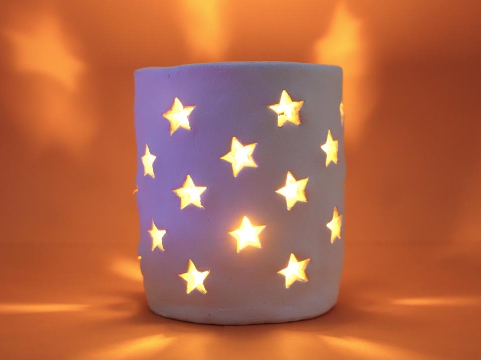 Air dry clay lamp with stars cut out to let light pass through