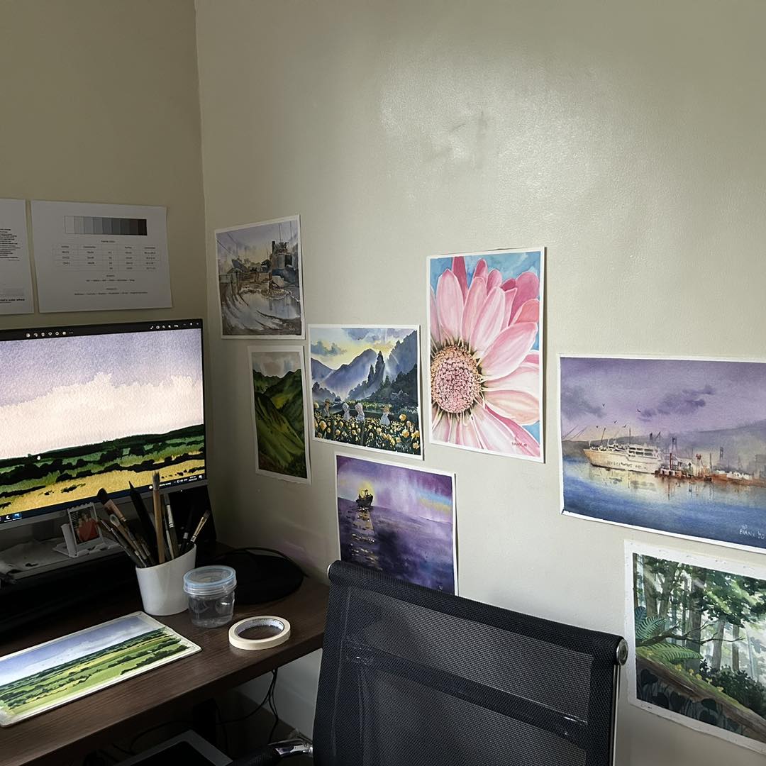 Bianca's office space with paintings on the walls by the desk