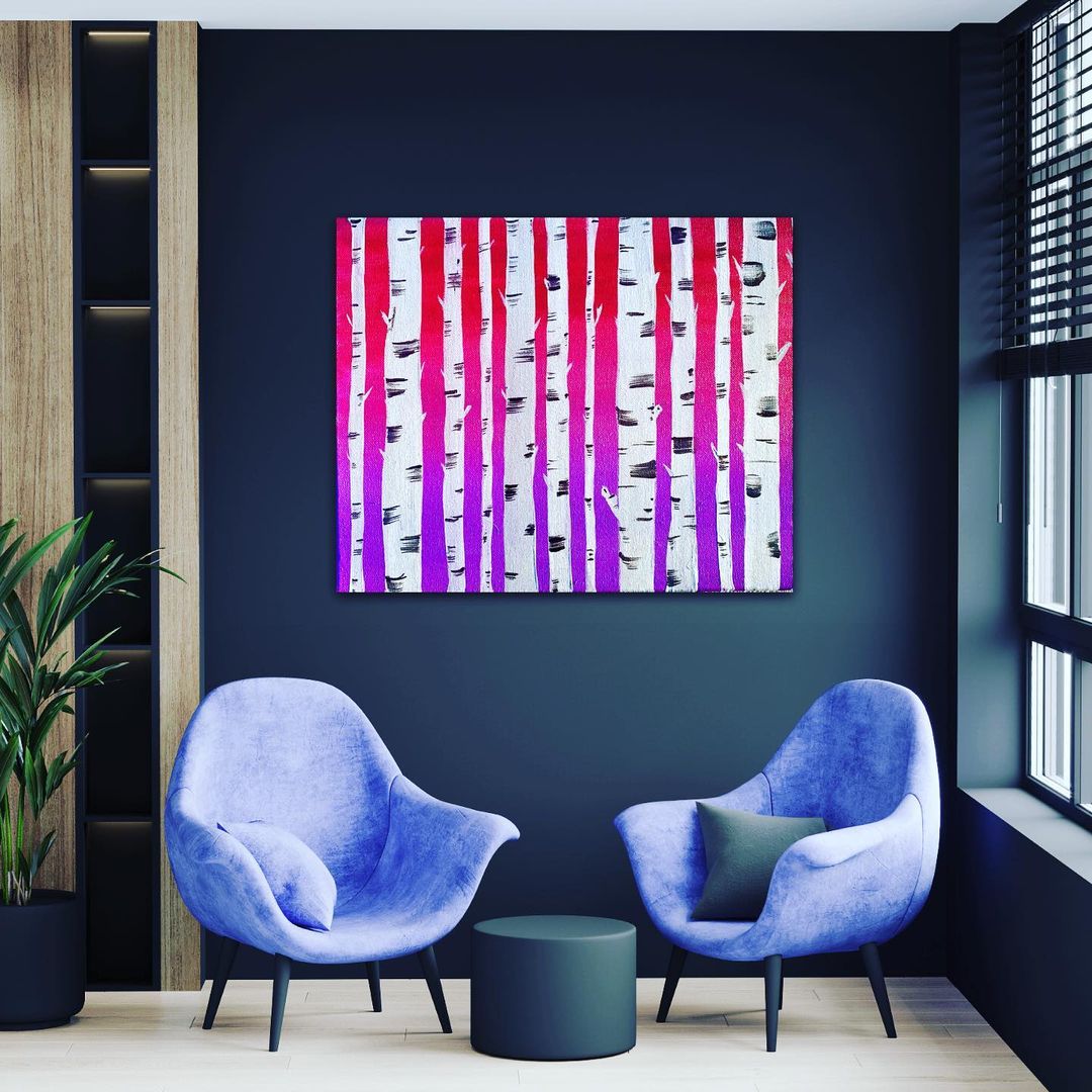 Birch tree trunk painting hung on a navy wall above two chairs