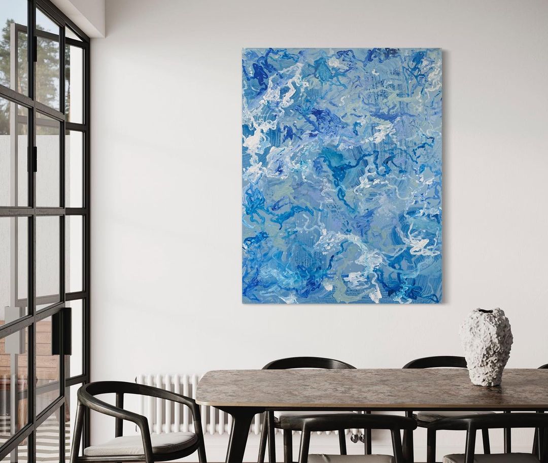 Blue abstract painting on canvas hanging on the wall in a dining roomBlue abstract painting on canvas hanging on the wall in a dining room