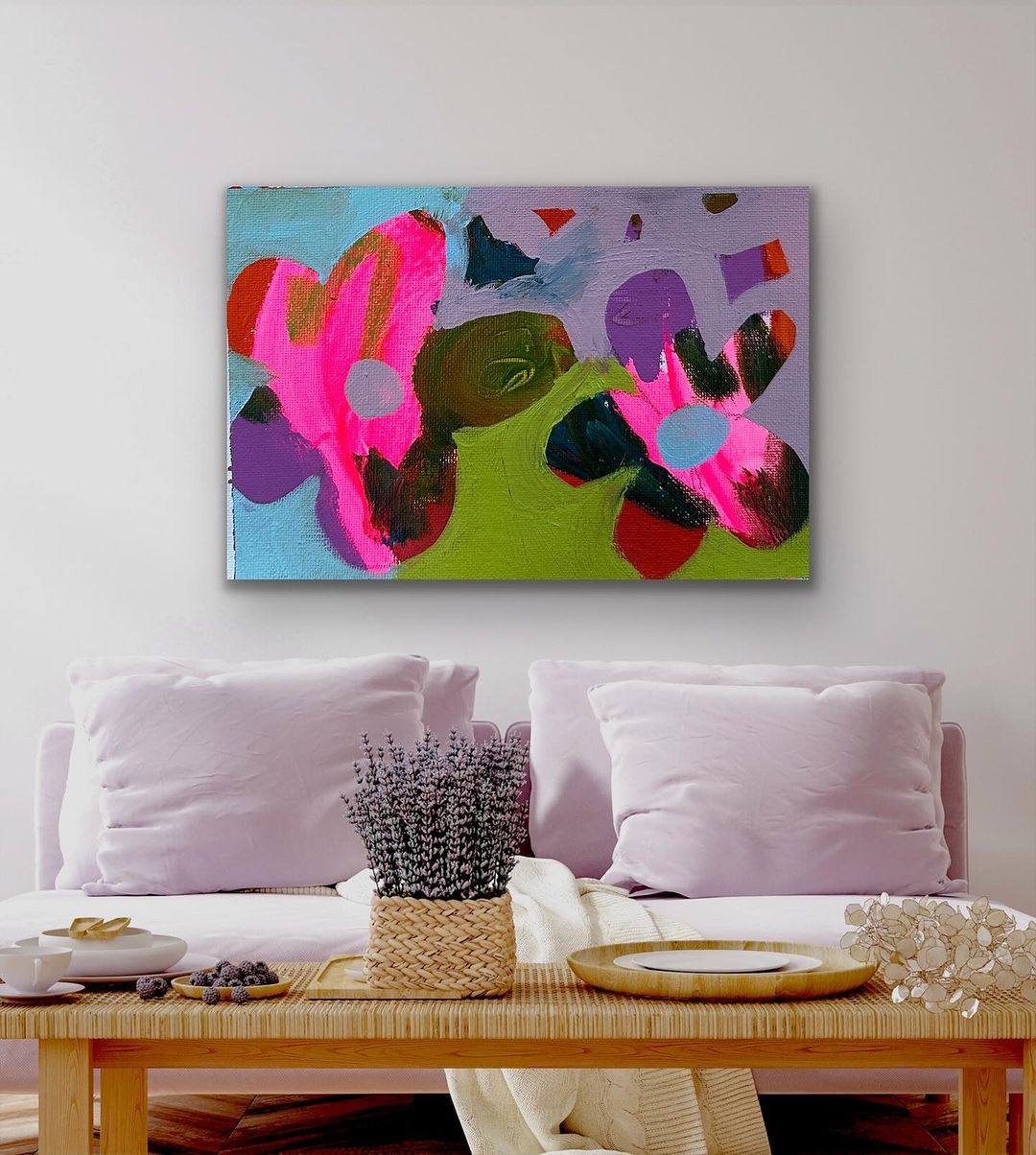 Bright flower painting on canvas hanging above couch