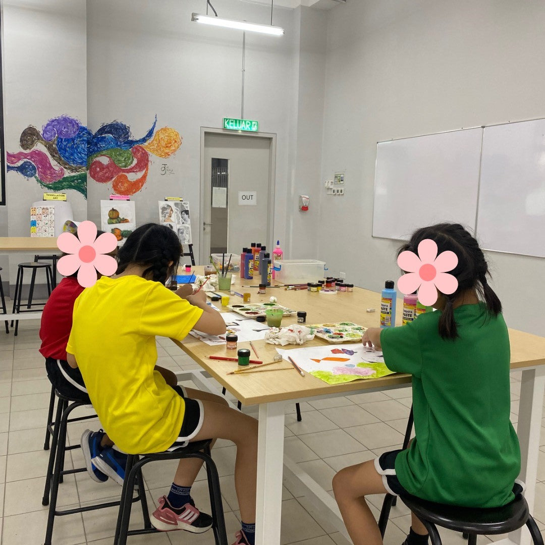 Children creating art in classroom at table