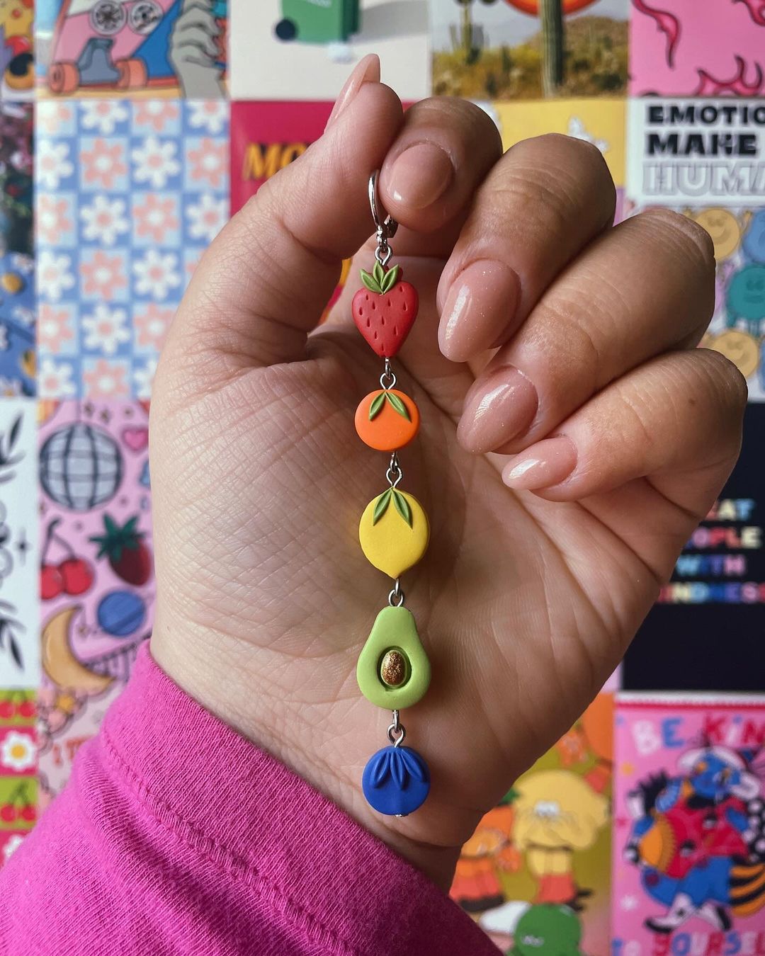 Clay fruit charms hanging vertically in a line