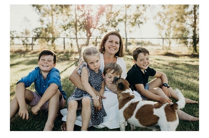 Jayde Chandler and her family smiling in the outback with the family dog.