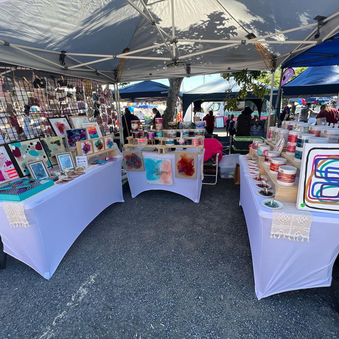 Lisa's market tent set up with her arts and crafts