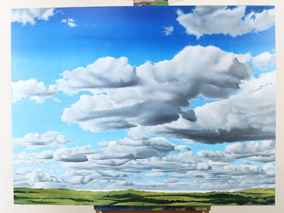 Realistic cloud landscape oil painting on an easel