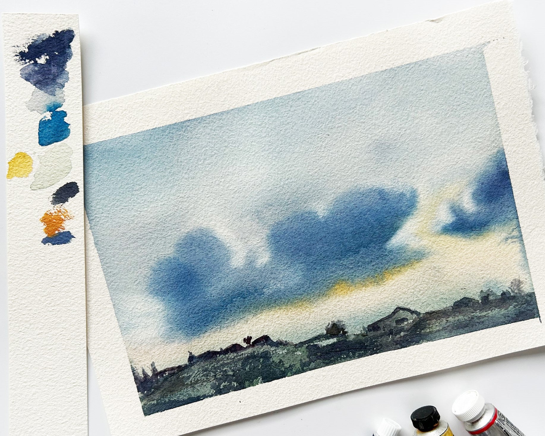 Watercolour landscape in muted blues and yellows