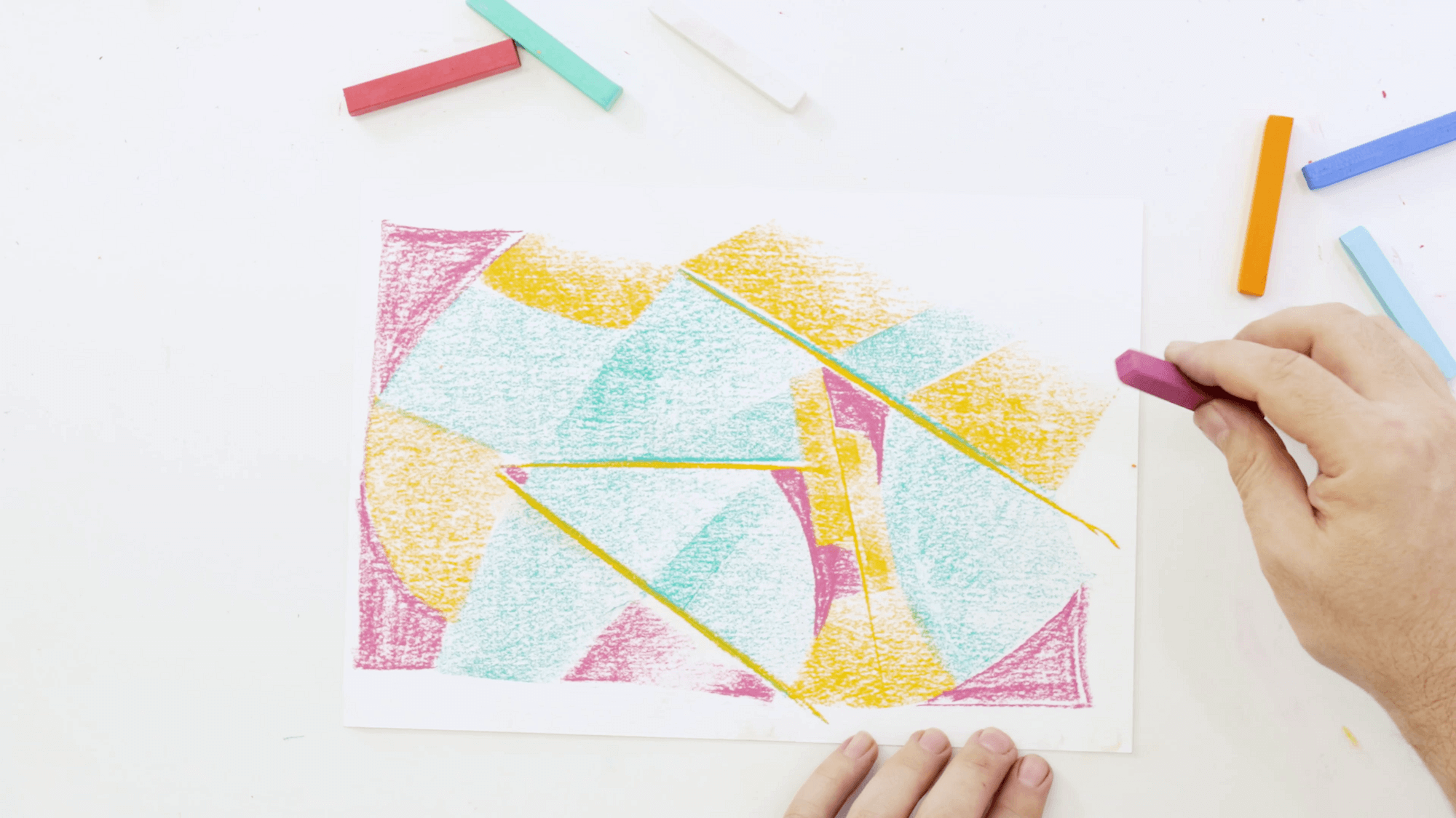 Hand colouring in with a soft pastel to create a geometric artwork. 