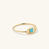 Evil Eye Turquoise Ring: A handcrafted 14k gold ring featuring a turquoise gemstone symbolizing protection, inspired by cultural traditions and designed by Mejuri's Noura Sakkijha.