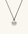 Amelia Shell Cord Necklace featuring an oversized silver shell pendant on a black cord, capturing a beach-inspired aesthetic for versatile, everyday wear.