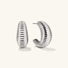 Dôme Texture Large Hoops: A pair of large, textured silver hoop earrings with a unique, curvy design, offering a stylish and modern accessory.