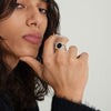 Close-up of a person wearing an Oval Gemstone Signet Ring on their finger, showcasing the ring's handcrafted sterling silver design.