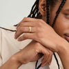 Man with braids displaying the 6mm Curve Band on his hand, highlighting its lightweight and durable design.