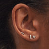 Diamond Lotus Flat Back Stud in white gold shown close-up on an ear, featuring three sparkling diamonds set in 14k solid gold with a comfortable threadless design.