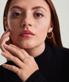 Close-up of a woman wearing the Pavé Diamond Slim Signet ring on her finger, highlighting the delicate diamond details and elegant design.