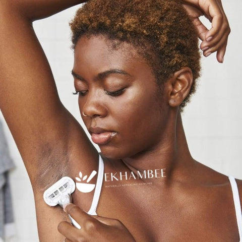 Black woman shaving discolored and dark underarm - Ekhambee logo shown
