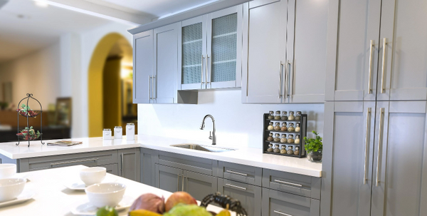 Grey shaker cabinets in a kitchen with white marble countertops